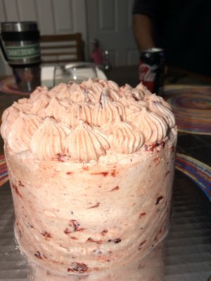 Personalized vegan lemon vanilla cake with strawberry icing and strawberry chunks at Fresh Levant Bistro in Raleigh