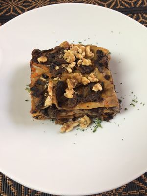Vegan  bran lasagna with pumpkin béchamel, mushrooms, radicchio and topped with walnuts at Giardino Tergesteo in Trieste