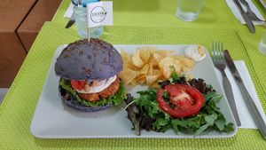 Peanut burger with salad and chips at Vegana Burgers - Cais do Sodre in Lisbon
