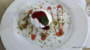 Homemade aquafaba meringue topped with forest fruits
and crushed pistachio nuts. at O'Vrakas Taverna in Limassol