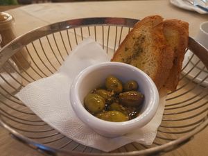 appetizer: toasted bread with olive oil and oregano and green olives on garlic and olive oil at O'Vrakas Taverna in Limassol