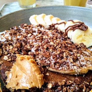 The Co'Yo Crazy vegan pancakes with coconut yoghurt, peanut butter, banana, maple syrup and chocolate sauce at O'YO - Brabantdam in Ghent