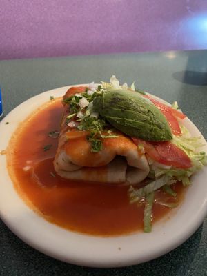 Vegan smothered burrito with the mild (orange) sauce. SO GOOD. Also gluten free tortilla (it was a few corn tortillas rolled together. Delicious!!!!)  at Morenita's in Idaho Falls