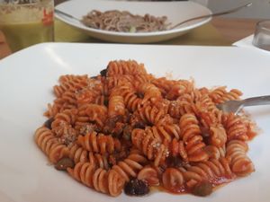 "fusilli di farro con pomodorini, olive e capperi" (emmer wheat fusilli with cherry tomatoes, olives and capers) at Bottega Vegana in Modena