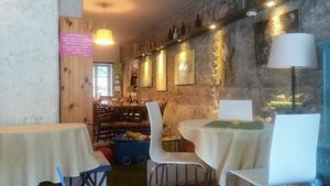 Interior with art and different styles of tables at Kuusk Hernesto in Tallinn