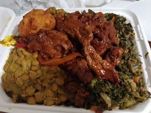 Noodles, curry chickpeas, greens, curried squash, BBQ soy curls and potato fritter $18.08 at Ital Vital in Toronto
