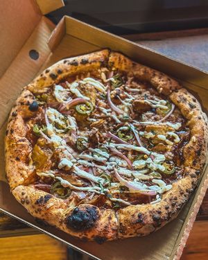 Smoky, sweet and savory pizza, with tender BBQ vegan chick’n, red onions, spicy jalapeños, and creamy aioli  at Red Sparrow Pizza in Collingwood