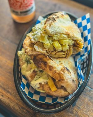 Chicken souvlaki pizza sandwich, with grilled lemon and herb chick’n, chunky skin on fries, tzatziki and mozzarella at Red Sparrow Pizza in Collingwood