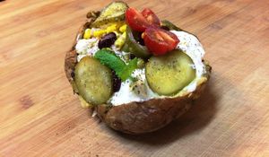 Vegeterian baked potato filled with different sauces and additional beans and herbs.   at Brunet Kafe in Warsaw