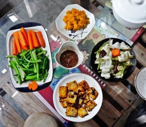a meal: mashed pumpkin, steamed and stir-fried veggies, lemongrass and turmeric tofu, miso dipping sauce at Thuc Duong Bao An - Bao An Macrobiotic in Da Nang