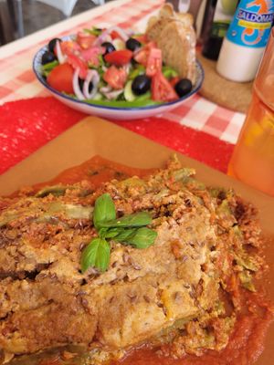 Lasagna with greek salad in the back at By Valeria in Santa Maria