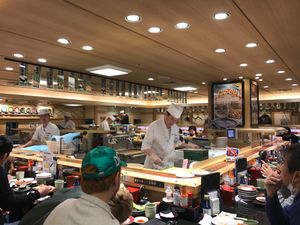 Sushi chefs behind the conveyor belt at Katsu Midori in Tokyo