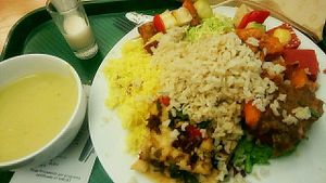 (all vegan) creamy green soup, a spicy coconut milk ";shot"; and on the plate : pumpkin bake (with a peanutty crust), brown rice, couscous, sort of seitan pizza with baked-in veggies, tofu sticks and two kinds of salad  at DaTerra - Bom Sucesso Markt in Porto