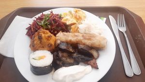 Sushi, breaded cauliflower, cabbage salad, spring roll, eggplant, sweet potato salad at Veganland - Karlovo Namesti in Prague