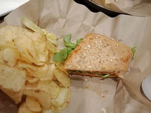 My half-devoured Hummazing Vegan sandwich.... and it really was Humming!! ? With a side of vegan in-house potato chips at Even Stevens Sandwiches in Logan