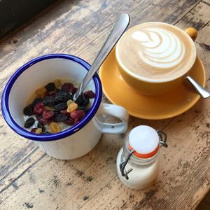 porridge with oat milk and cranberries oat latte  at Fig and Sparrow in Manchester