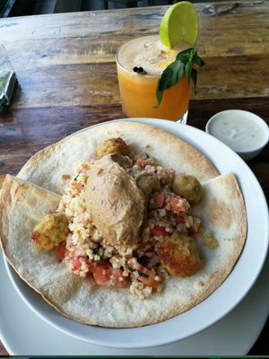 Bulgur tabbouleh with hummus and falafel and a glass of fresh pressed juice at Organic Cafe in Fuengirola