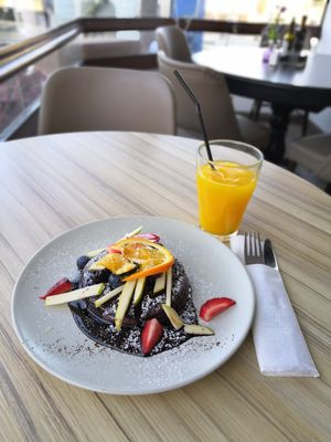 Vegan chocolate cardamon pancakes and orange juice at Organic Cafe in Fuengirola