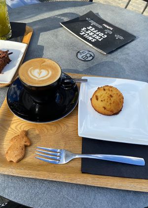 Cappuccino, coco ball (and extra biscuit that came with the coffee, also vegan)  at Kaffabar in Brussels