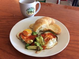 Light Breakfast croissant w eggs in green bell pepper rims & avocado  at Peace Nation  in Kingston