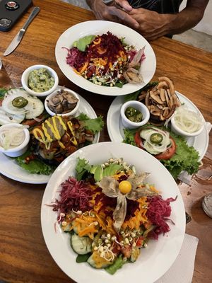 Big Green Salads with the philly chess (left w/ extra sides) and the coco bacon (right with extra sides). at Luv Burger in Nosara