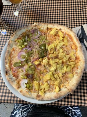 Half/half of two of the vegan pizza options with vegan cheese  at Pizza Paco in Barcelona