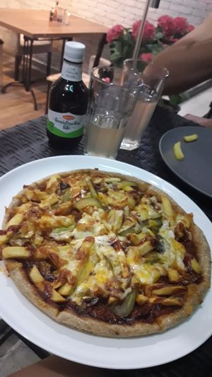 American burger pizza with fries at Vege Joy in Varna