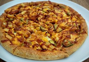 American Vege Burger Pizza (whole grain crust, tomato sauce, organic soy mince, French fries, pickles, chives, barbecue sauce, mozzarella) – vegan option mozzarella Violife at Vege Joy in Varna