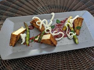 Grilled Smoked Tofu with Asparagus & Noodle Chips (smoked tofu, fresh asparagus, chilli jam, rice noodles)  at Vege Joy in Varna