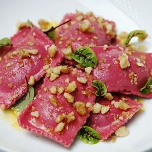 Ou rRavioli filled with a mouth-watering cream of Butternut Pumpkin, Sweet Potatoes and garden-fresh mix of herbs: Oregano, Basil and Marjoram folded into a velvety Beetroot pasta served with caramelized wallnuts and baby herbs!
 at GogoVego in Dulwich Hill