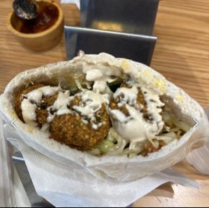 Falafel pita with spicy sauce on the sidee  at Pita Bakery in Central Singapore