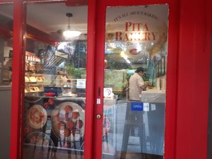 Little sweet place with two tables outside at Pita Bakery in Central Singapore