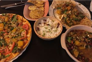 Vegan pizza, tostones, rice, veggie tacos, and black bean stew at El Shamuskia'o in Havana