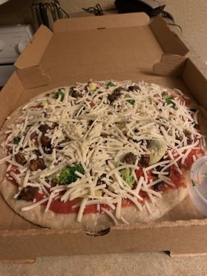 Take-and-bake vegetazione vegan pizza! We froze it and baked at home per instructions, and it was incredible !  at Baba Louie's Sourdough Pizza in Great Barrington