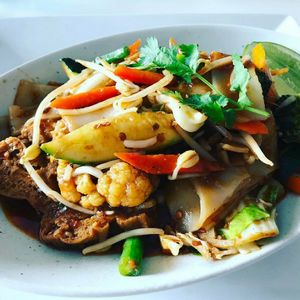 Chilli Tofu with market mixed vegetables, fresh flat rice noodles & chilli sauce.  (VEGAN) at Mr Soy Boy in Earlville