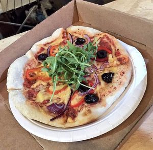 pizza with olives, onions and topped with rocket  at Vegan Pizza Co. in Cardiff