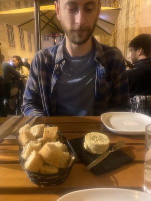 Eyeing the homemade almond cheese and bread   at Organi Chiado in Lisbon