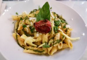 Penne pasta with cashew tomato sauce and vegan mozzarella cheese at Organi Chiado in Lisbon