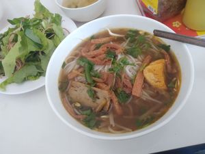 Bun Kho served with a plate of salad, leaves and herbs at An Lac in Kon Tum