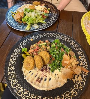 Menu 1 & 2: falafel, humous, fava beans and chickpea, tabbouleh (closest), baba ganoush and salad (furthest). Comes with bread on the side  at Falafel Koy in Istanbul