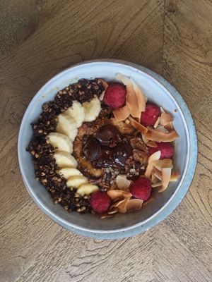 Espresso-chocolate porridge with homemade brownies, banana, dark chocolate, roasted coconut and raspberries. at Brochan in Edinburgh
