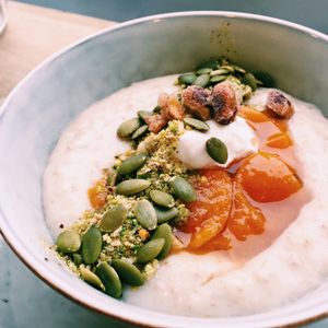 Rosemary apricot porridge made with coconut milk, with candied pistachios, oatly creme fraiche, pistachio crumb and pepitas. Incredible  at Brochan in Edinburgh