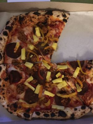 Supreme pizza with pineapple, peppers, vegan pepperoni and sausage  at Floralia in Honolulu