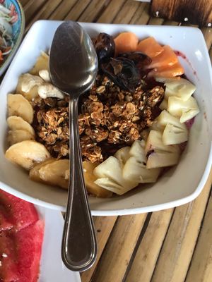 Energy fruit bowl. Delish granola papaya pineapple dates dragon fruit.  I’ll be dreaming about this one when we leave. So good  at Green Leaf Cafe in Jemuluk