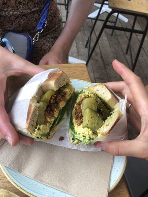 Bagel with pickles, scrambled tofu, tofu bacon and spinach (£8.40).  at The Fields Beneath - Kentish Town in North West London