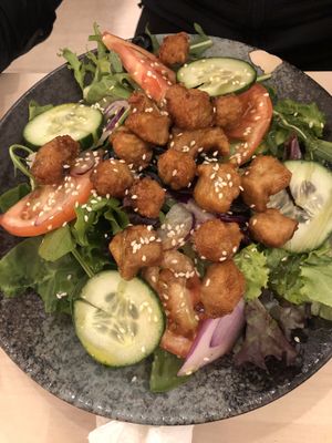 Salad with vegan cheese, tofu, and chicken popcorn at Chillin' Cafe in Madrid