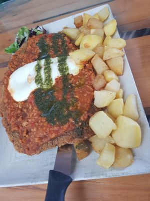 Cachopo (cheese-filled cutlet) with bolognese and pesto at El Manglar in Oviedo