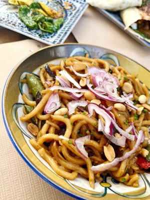 Juicy udon with vegetables wok, nuts, fried onions and cilantro at El Manglar in Oviedo