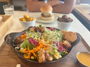 Power Salad with carrot dressing and extra tofu nuggets, sake kasu burger, fried herb potatoes, and soy meat  at Fluunt KOFU in Kofu