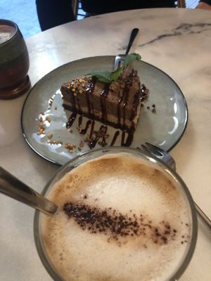 Raw cake and Oat Milk Coffee at Pura in Luzern